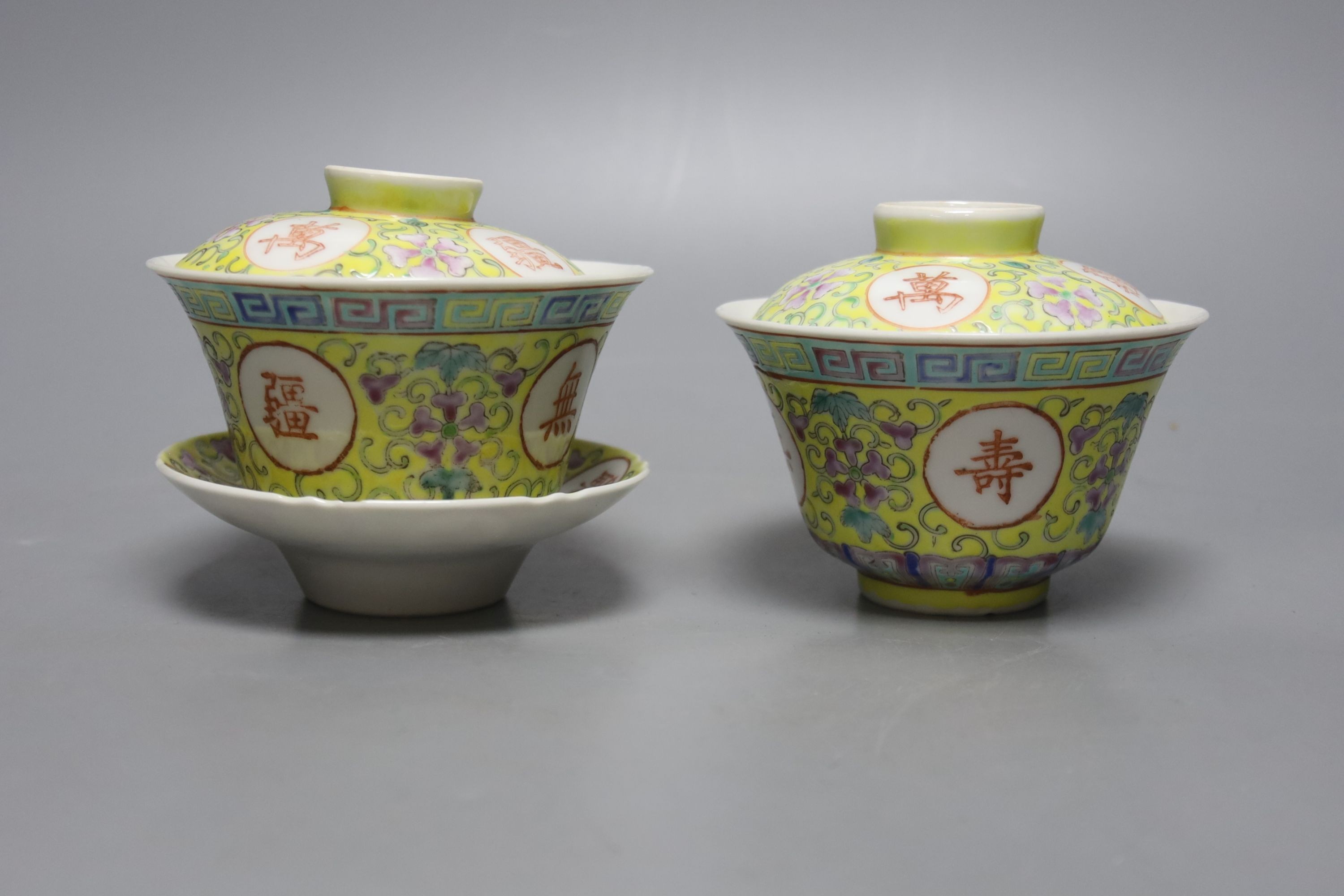 A pair of Chinese enamelled porcelain rice bowls, covers and stands and an odd bowl